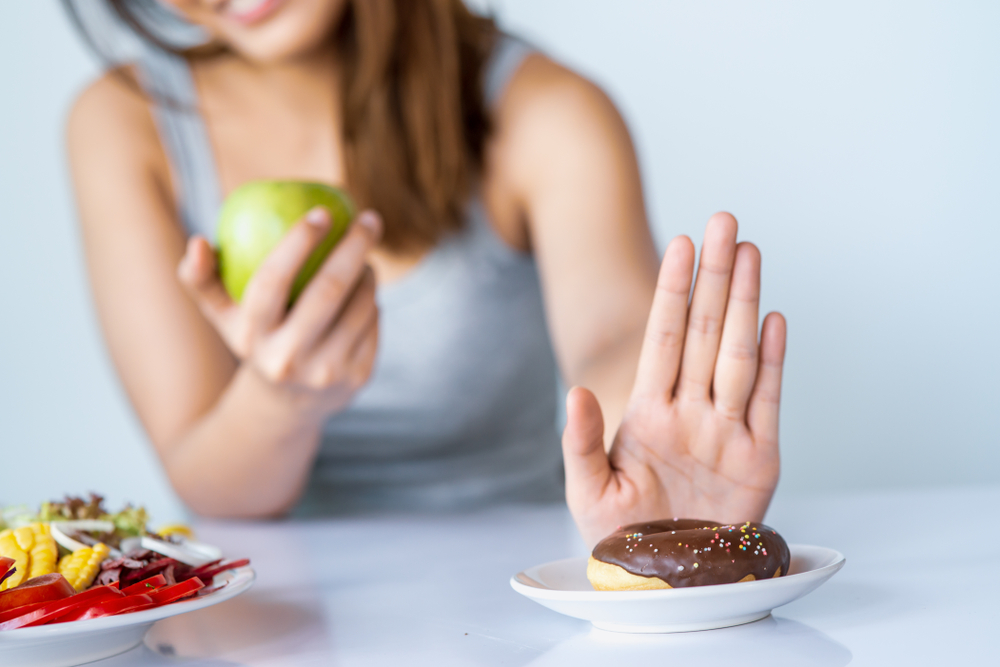 Похудела ела только овощи. Diet women reject Junk food or unhealthy foods. Going on a Diet. Woman Color dieta Shutterstock. People should avoid eating Junk food.