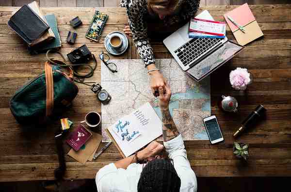 aerial-view-man-holding-woman-hand-map (1) Profitable Travel Business Startup Ideas